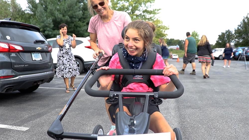  One of our happy campers riding her new adaptive bike!